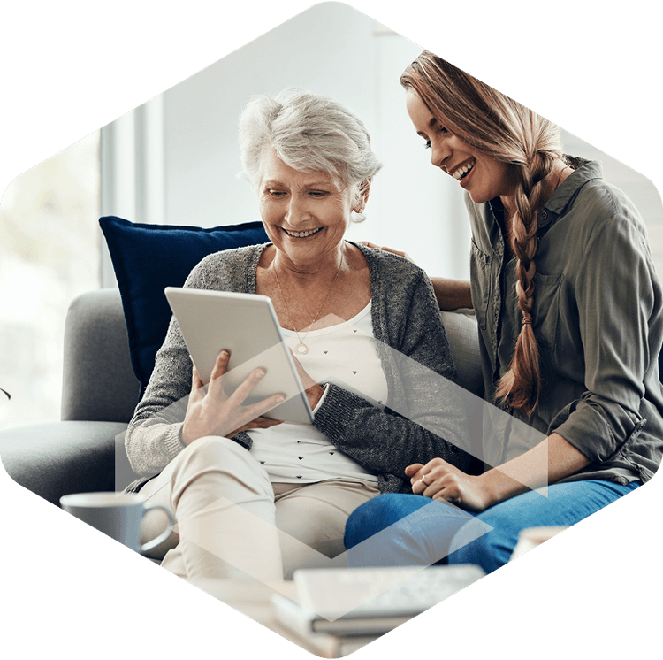 Caregiver and resident looking at a tablet together