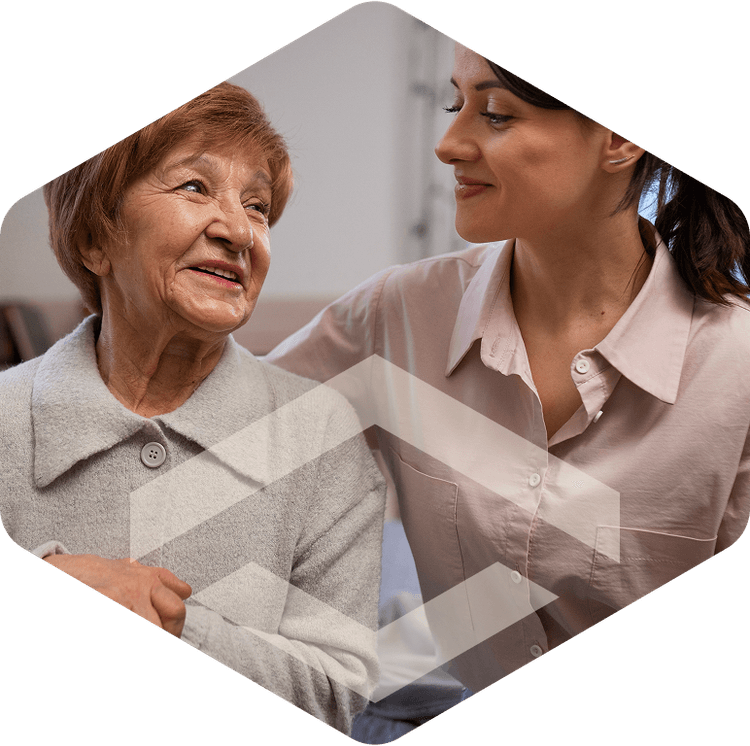 Nurse and elderly resident smiling together