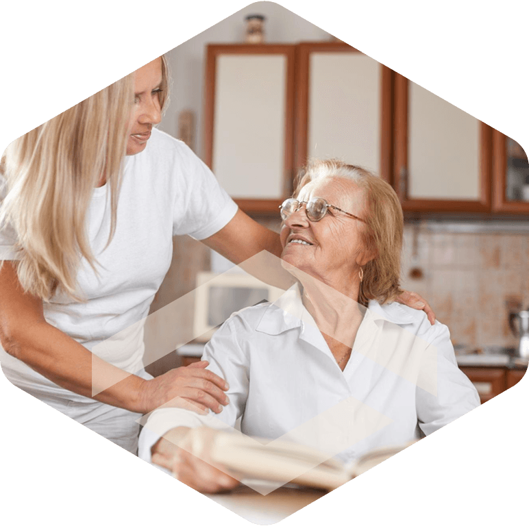 Caregiver smiling with an elderly resident
